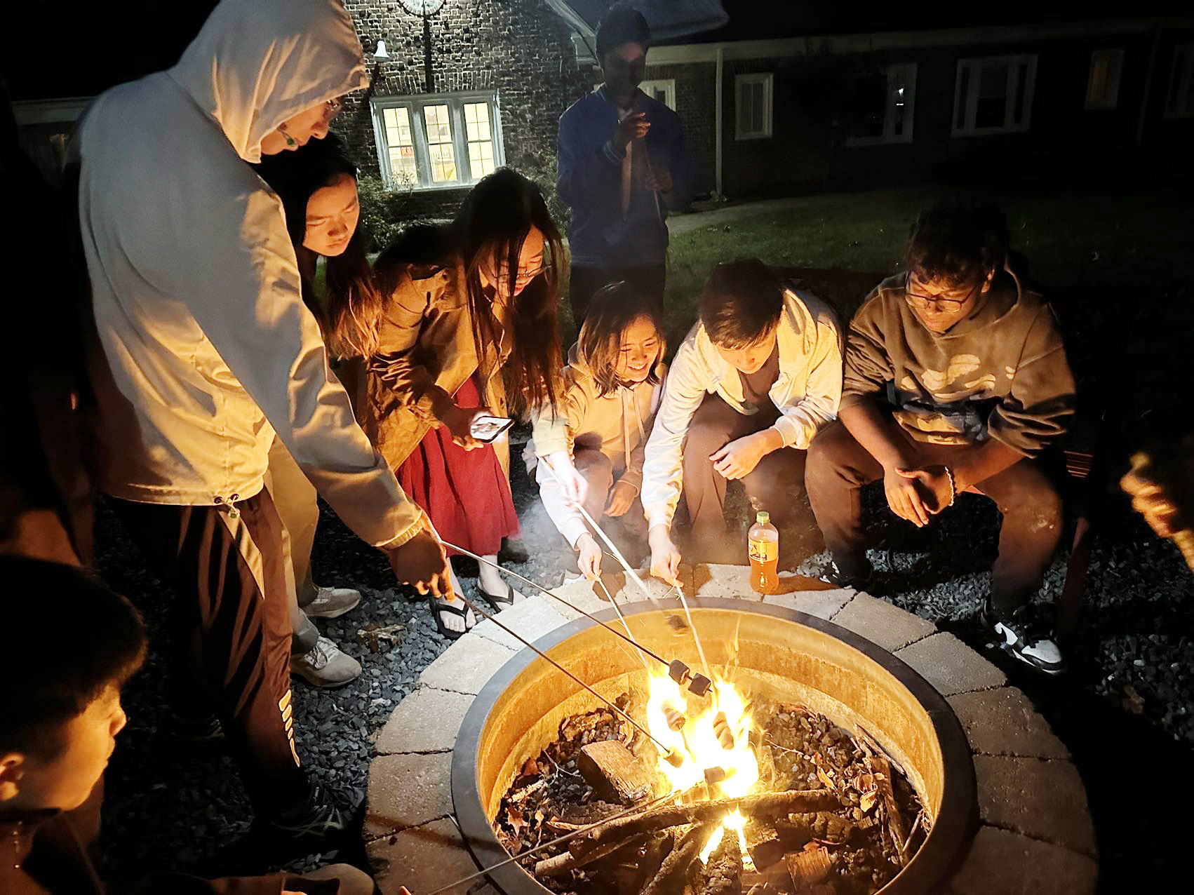 Students gathered around a fire